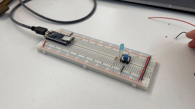 breadboard with arduino powering a blue LED with a switch and resistor