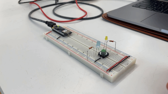 two LEDs in series with a switch on a breadboard powered by an arduino