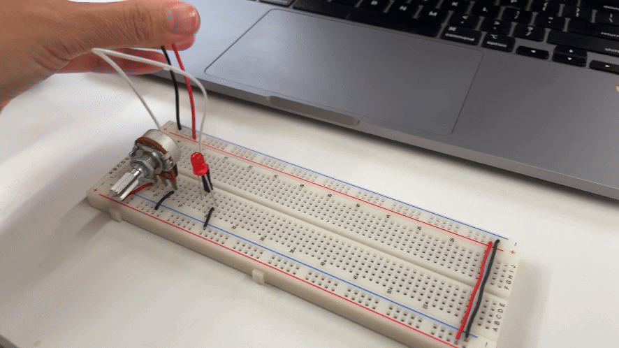 Red LED powered by a 9V battery on a breadboard, controlled by a potentiometer